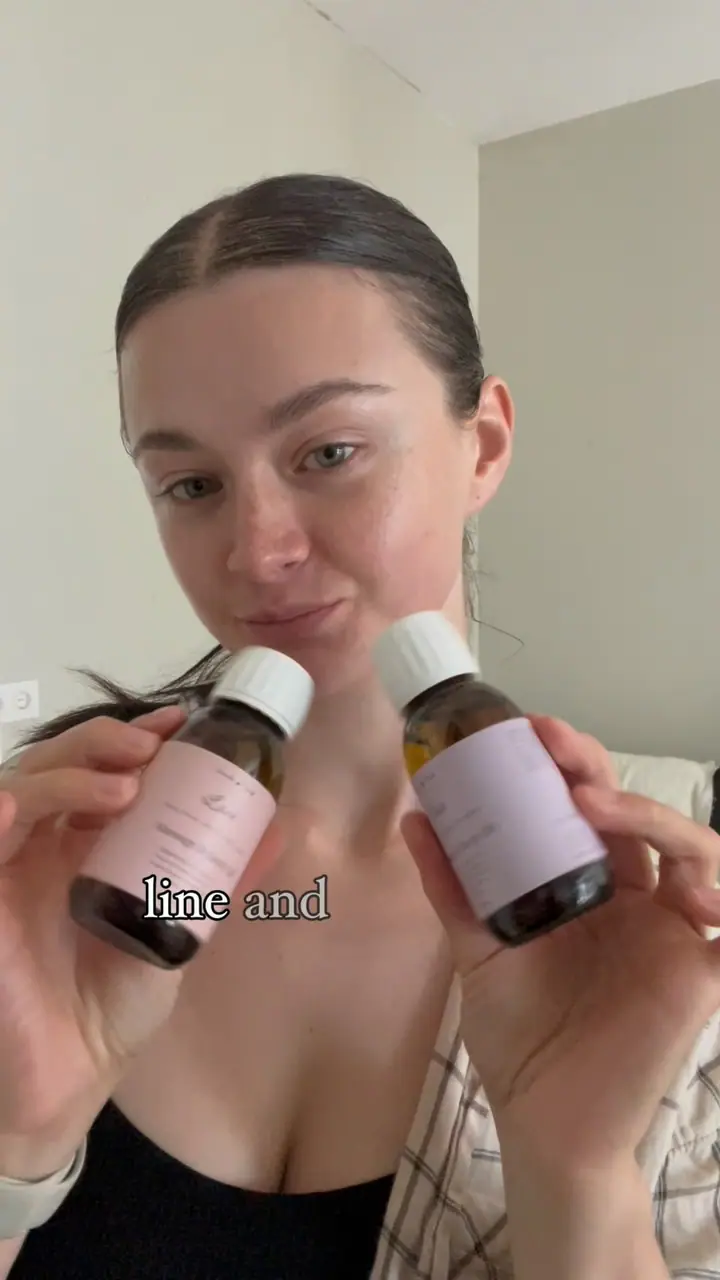 Holding two House of Gandha aromatherapy blends