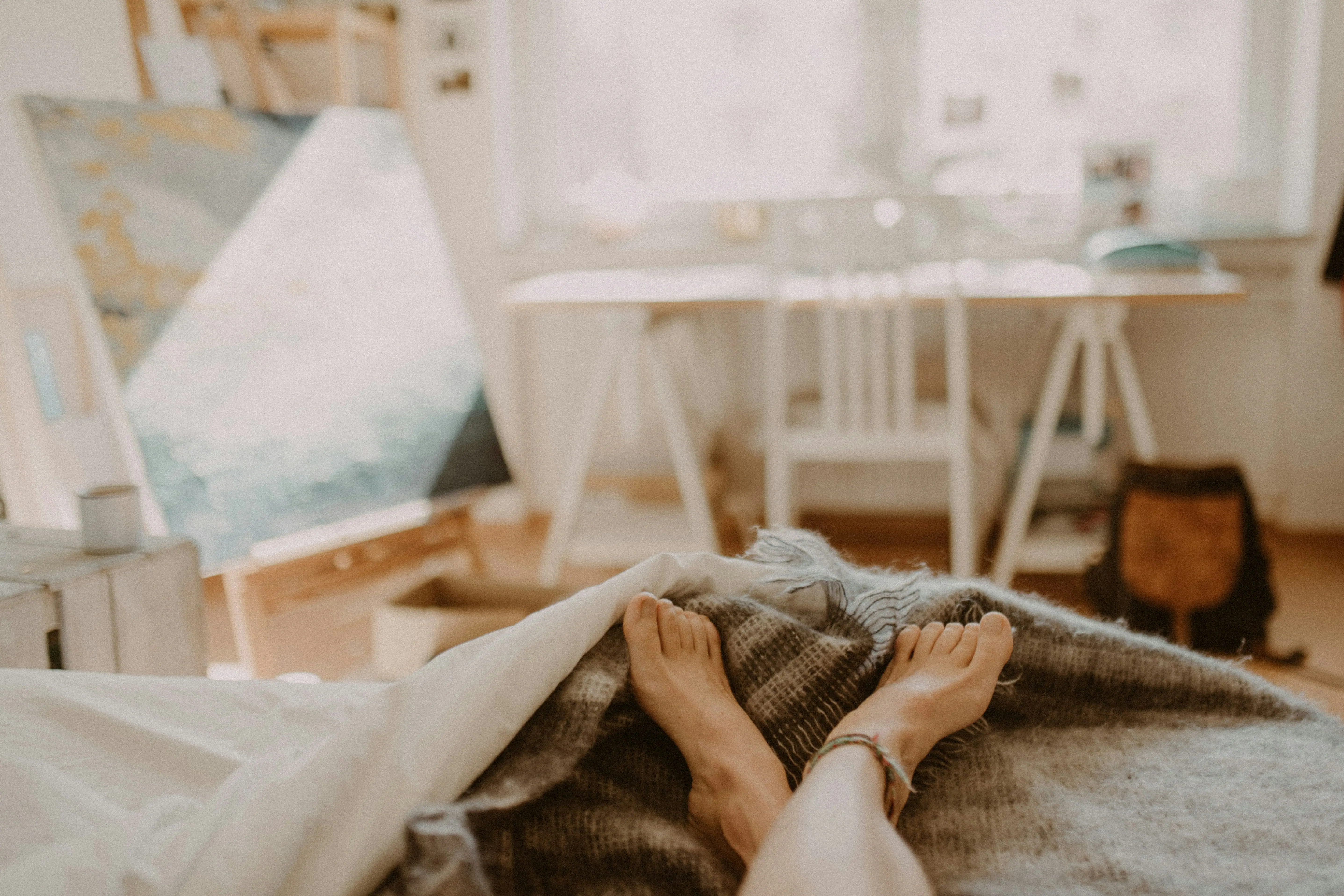 A person resting with bare feet up during a quiet evening at home