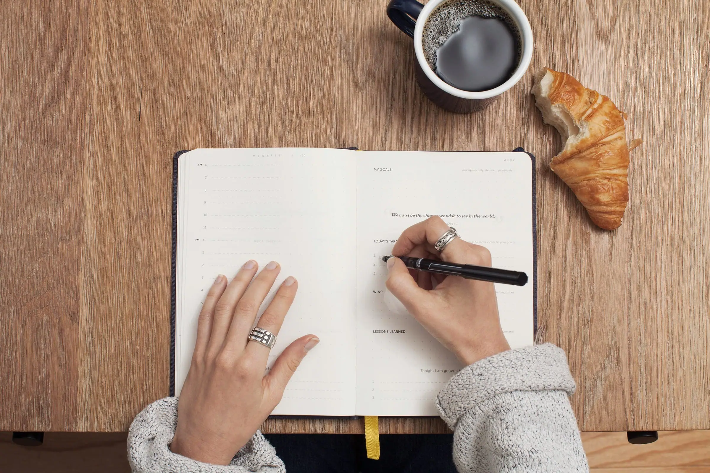 A notebook and breakfast prepared by a bright morning window