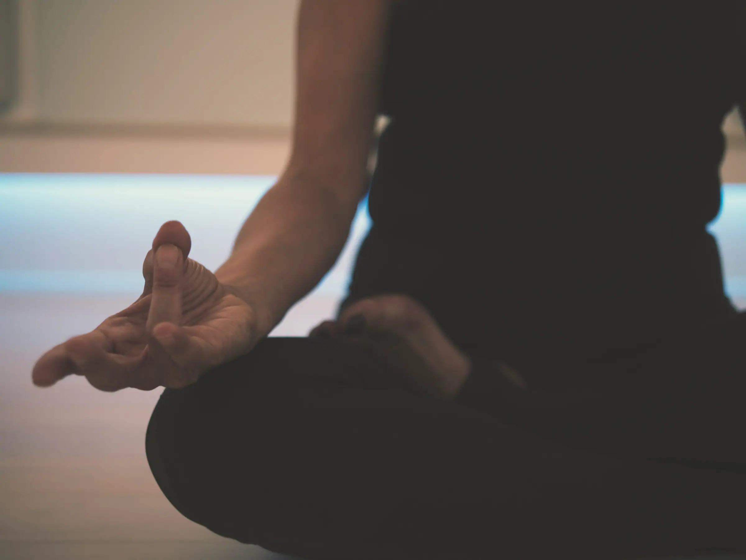 A person sitting comfortably with hands resting in their lap