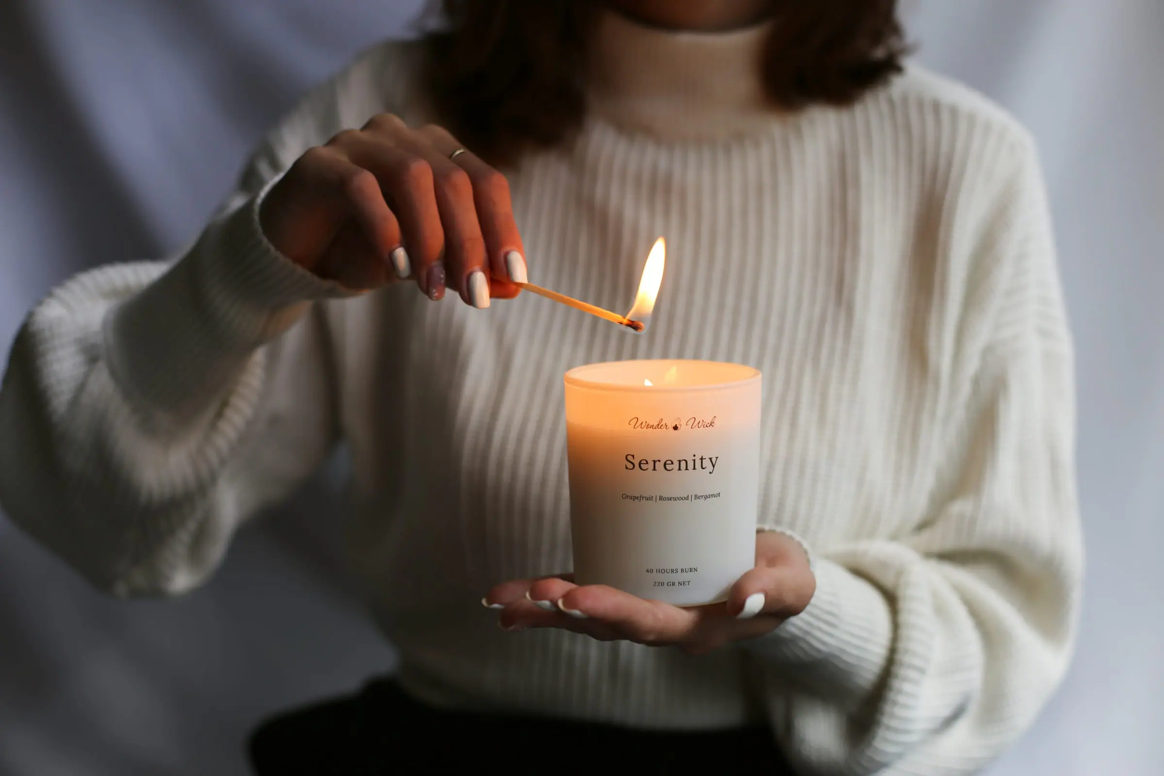 Lighting a Serenity aromatherapy candle by House of Gandha